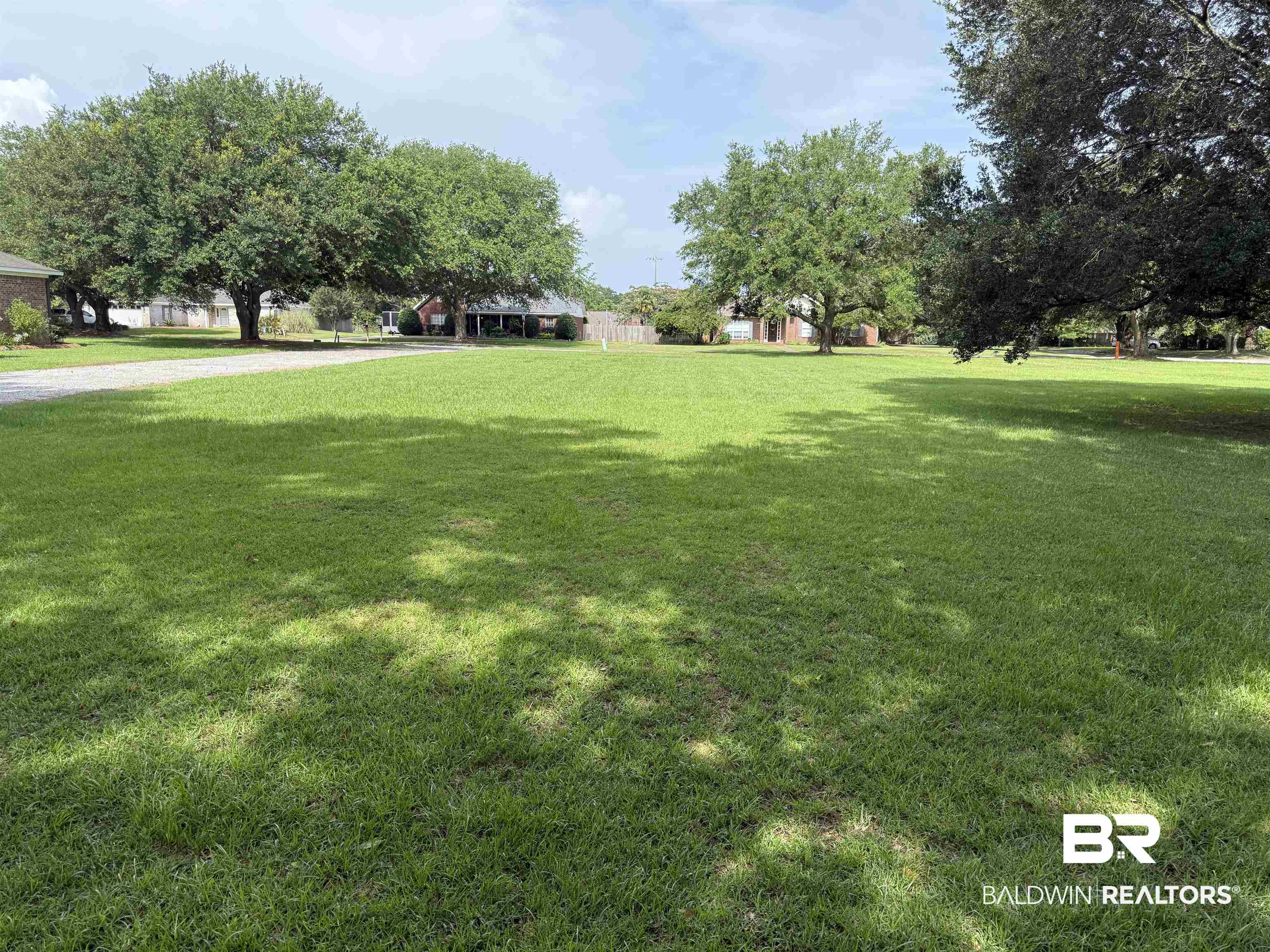 0 Gale Rowe Lane Fairhope, AL 36532 - Photo 2 of 3 View of green lawn featuring gravel driveway