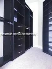 a kitchen with a refrigerator and a wall