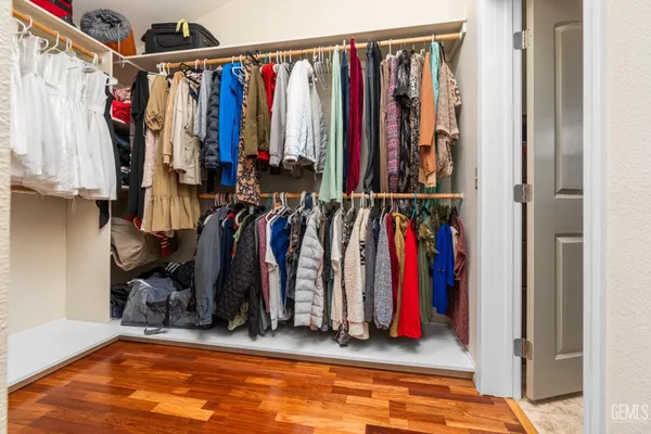 a view of walk in closet with clothes