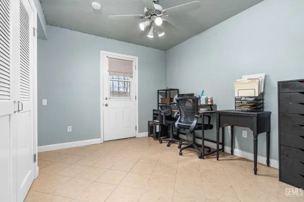 a view of a workspace with furniture and a window