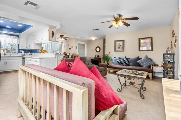 a living room with furniture and kitchen view