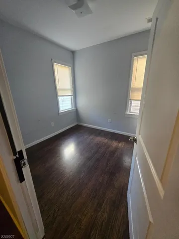 a view of room with window and hardwood floor