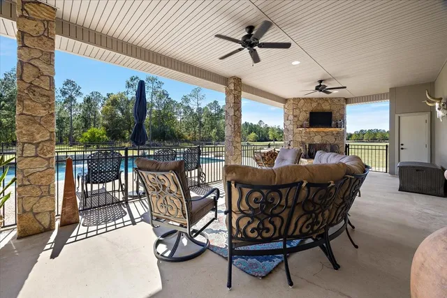 a kitchen with stainless steel appliances granite countertop a sink a stove and a wooden floors