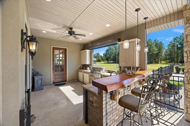 a view of a patio with table and chairs