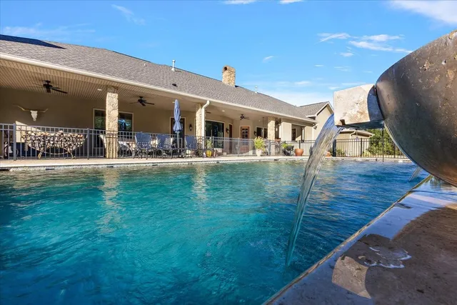 a kitchen with a refrigerator a sink cabinets and wooden floor