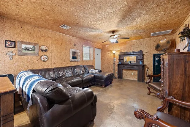 a living room with furniture and a pool table