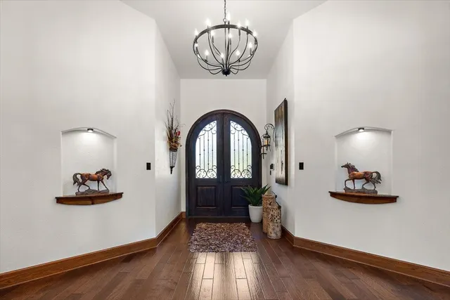 a living room with furniture kitchen view and a large window