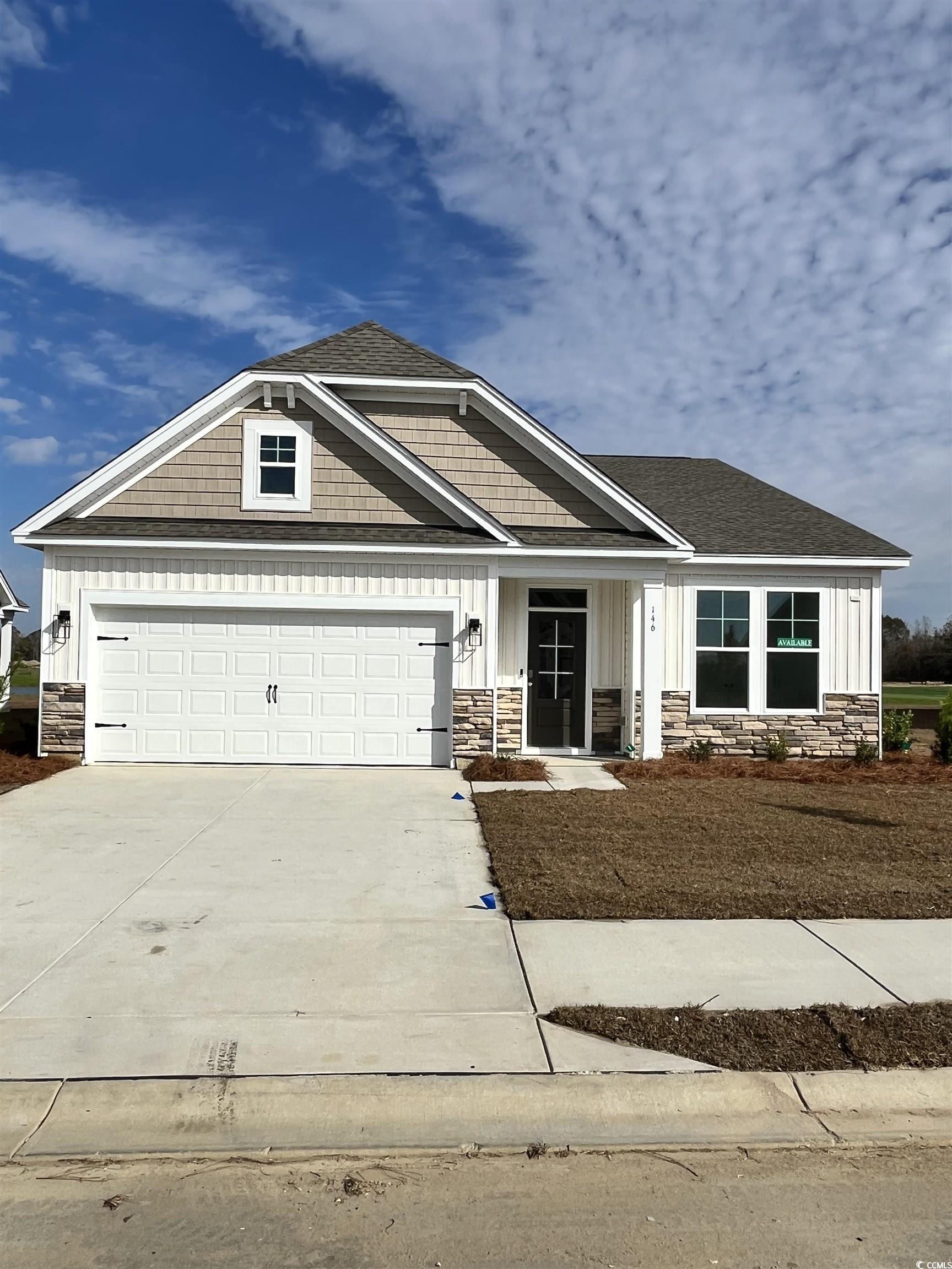Craftsman-style home featuring stone siding, driveway, board and batten siding, a garage, and a shingled roof