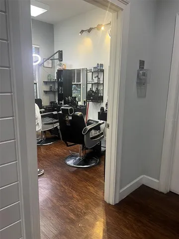 a kitchen with a refrigerator and a stove top oven