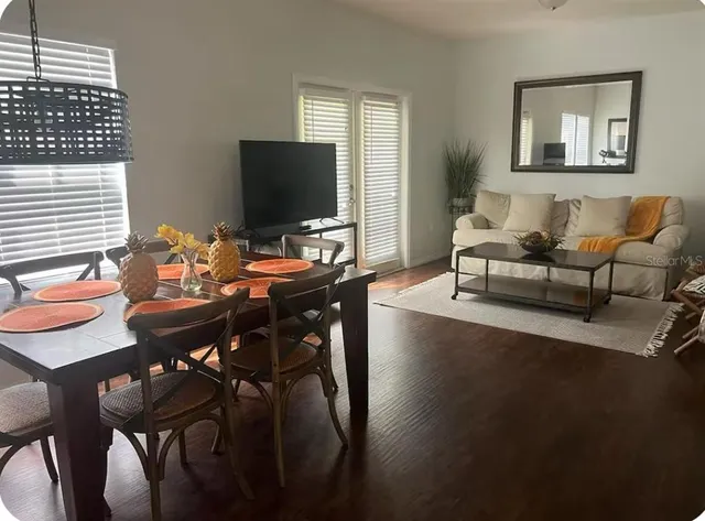 a view of a dining room with furniture and wooden floor