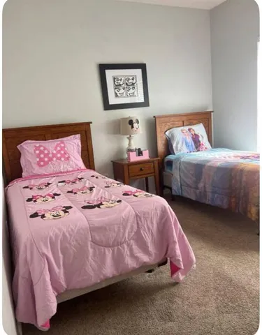 a bedroom with two beds and a couch