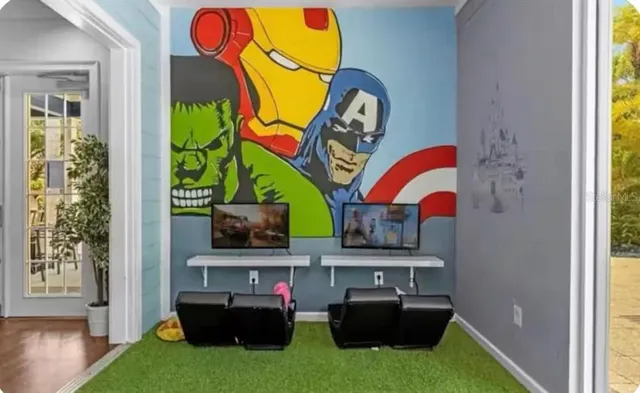 a living room with furniture and wall paintings