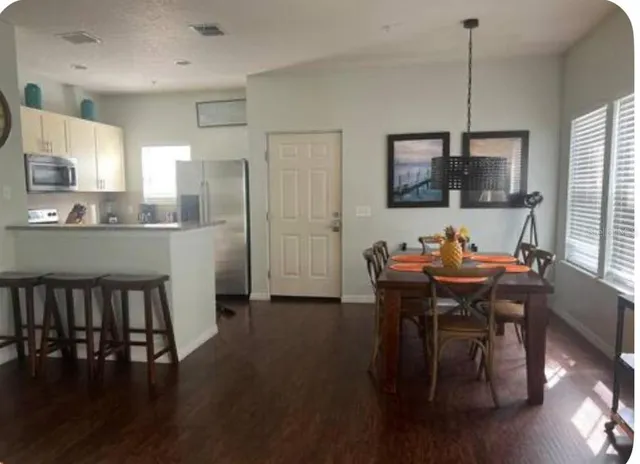 a view of a dining room with furniture and window