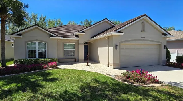 a front view of a house with a yard and garage