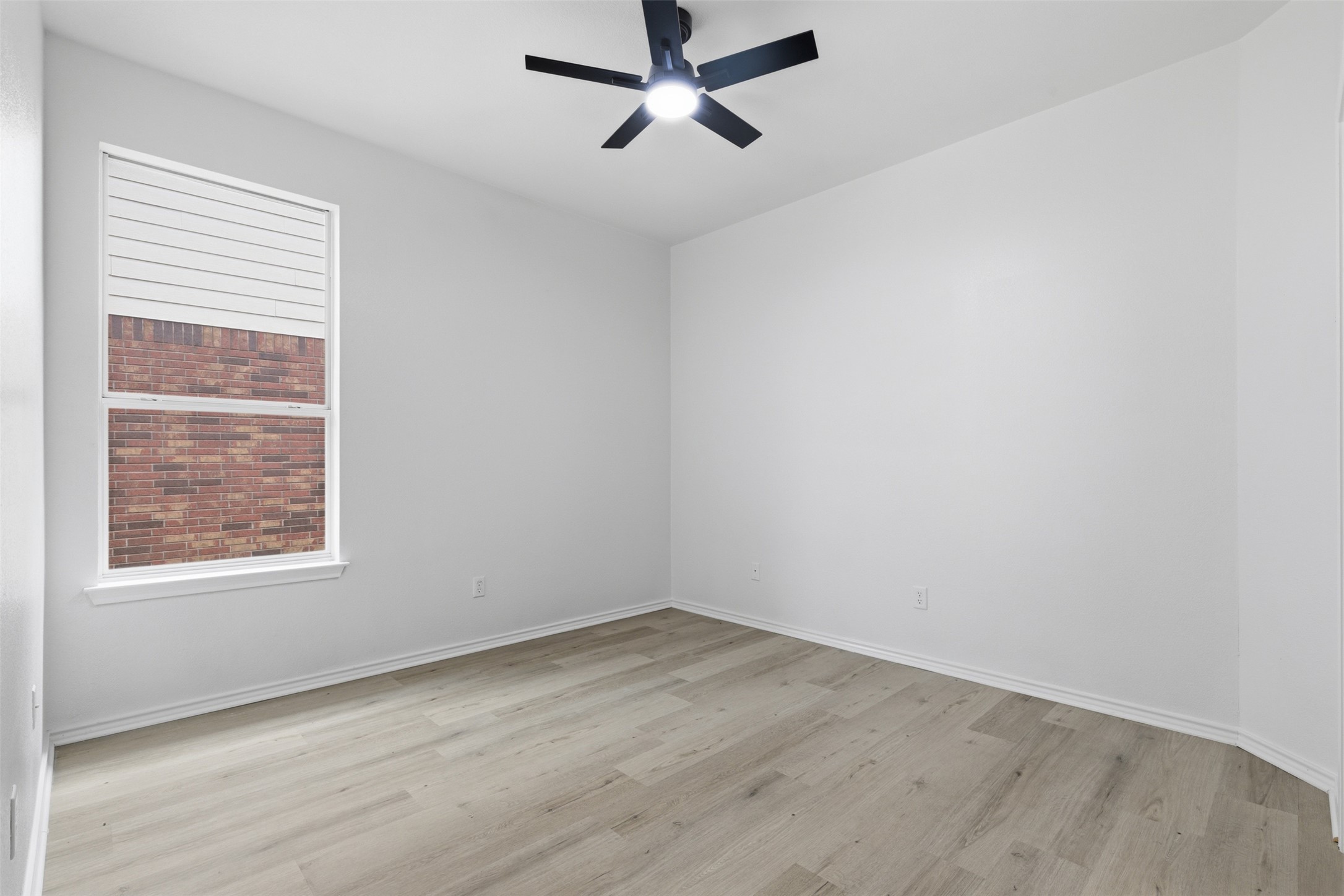 461 Hot Spring Valley Buda, TX 78610 - Photo 17 of 25 This room features light-colored flooring, a window with blinds, and a ceiling fan with integrated lighting