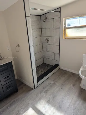a view of wooden floor and cabinet in a room