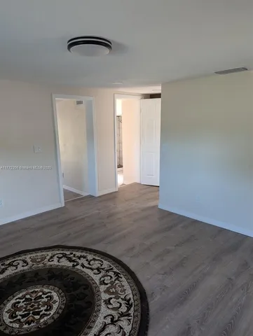 a view of hallway with wooden floor
