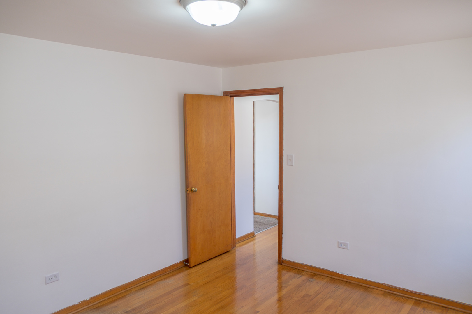 5520 South Pulaski Road, Unit 2 Chicago, IL 60629 - Photo 22 of 44 a view of an empty room with wooden floor
