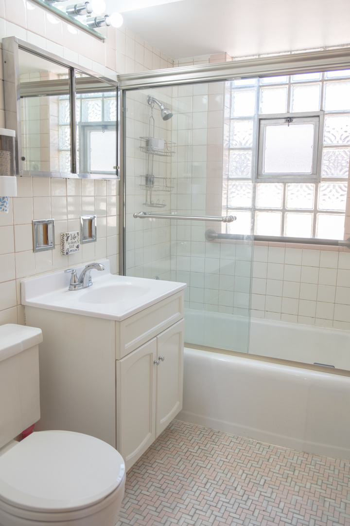 5520 South Pulaski Road, Unit 2 Chicago, IL 60629 - Photo 24 of 44 a bathroom with a sink a toilet and shower