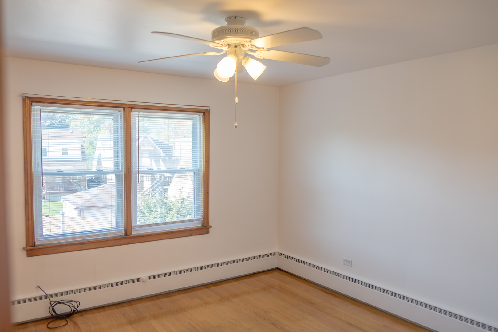 5520 South Pulaski Road, Unit 2 Chicago, IL 60629 - Photo 28 of 44 wooden floor in an empty room with a window