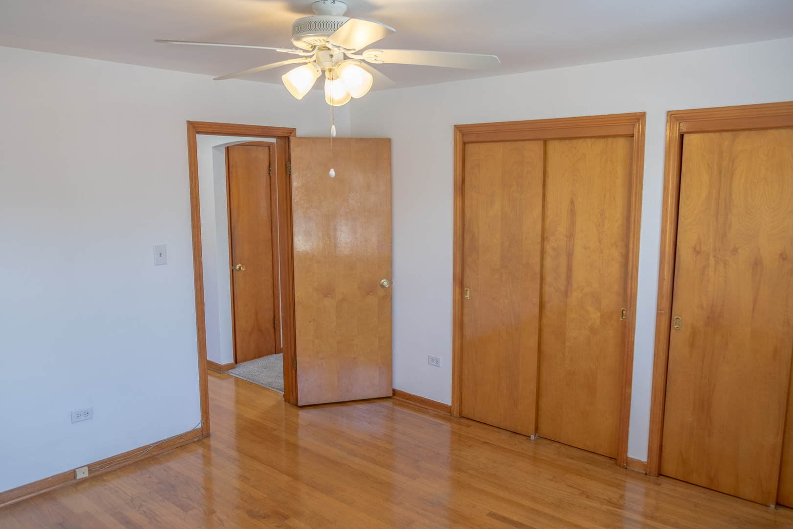 5520 South Pulaski Road, Unit 2 Chicago, IL 60629 - Photo 29 of 44 an empty room with wooden floor closet and windows
