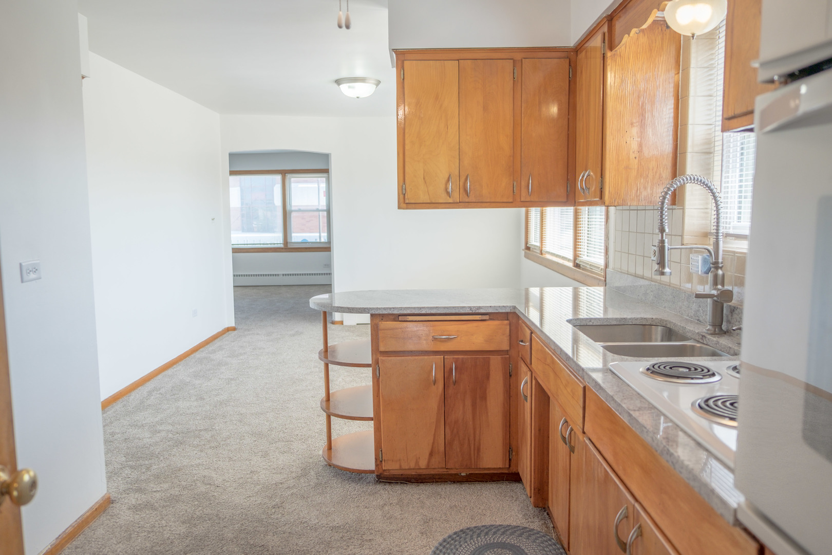 5520 South Pulaski Road, Unit 2 Chicago, IL 60629 - Photo 3 of 44 a kitchen that has a sink a stove and a window