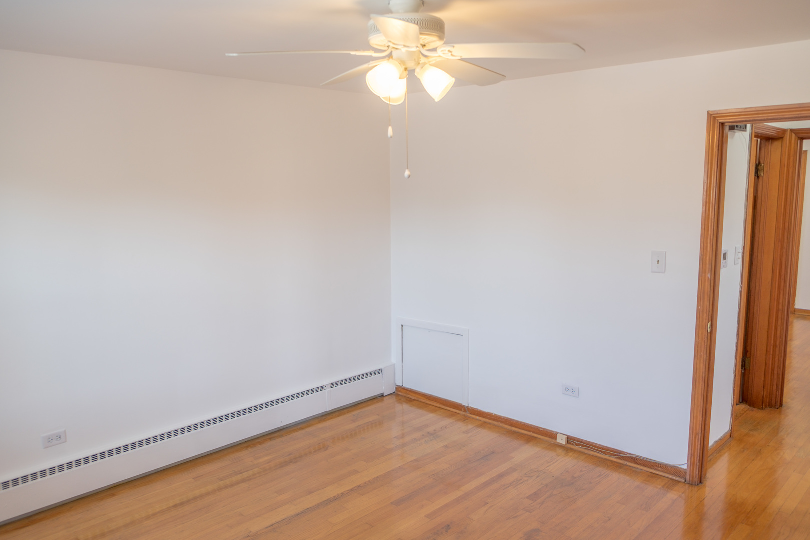 5520 South Pulaski Road, Unit 2 Chicago, IL 60629 - Photo 31 of 44 a view of an empty room with window and wooden floor