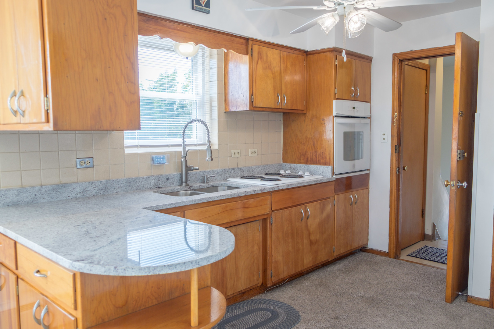 5520 South Pulaski Road, Unit 2 Chicago, IL 60629 - Photo 4 of 44 a kitchen with stainless steel appliances granite countertop a sink a stove and a refrigerator