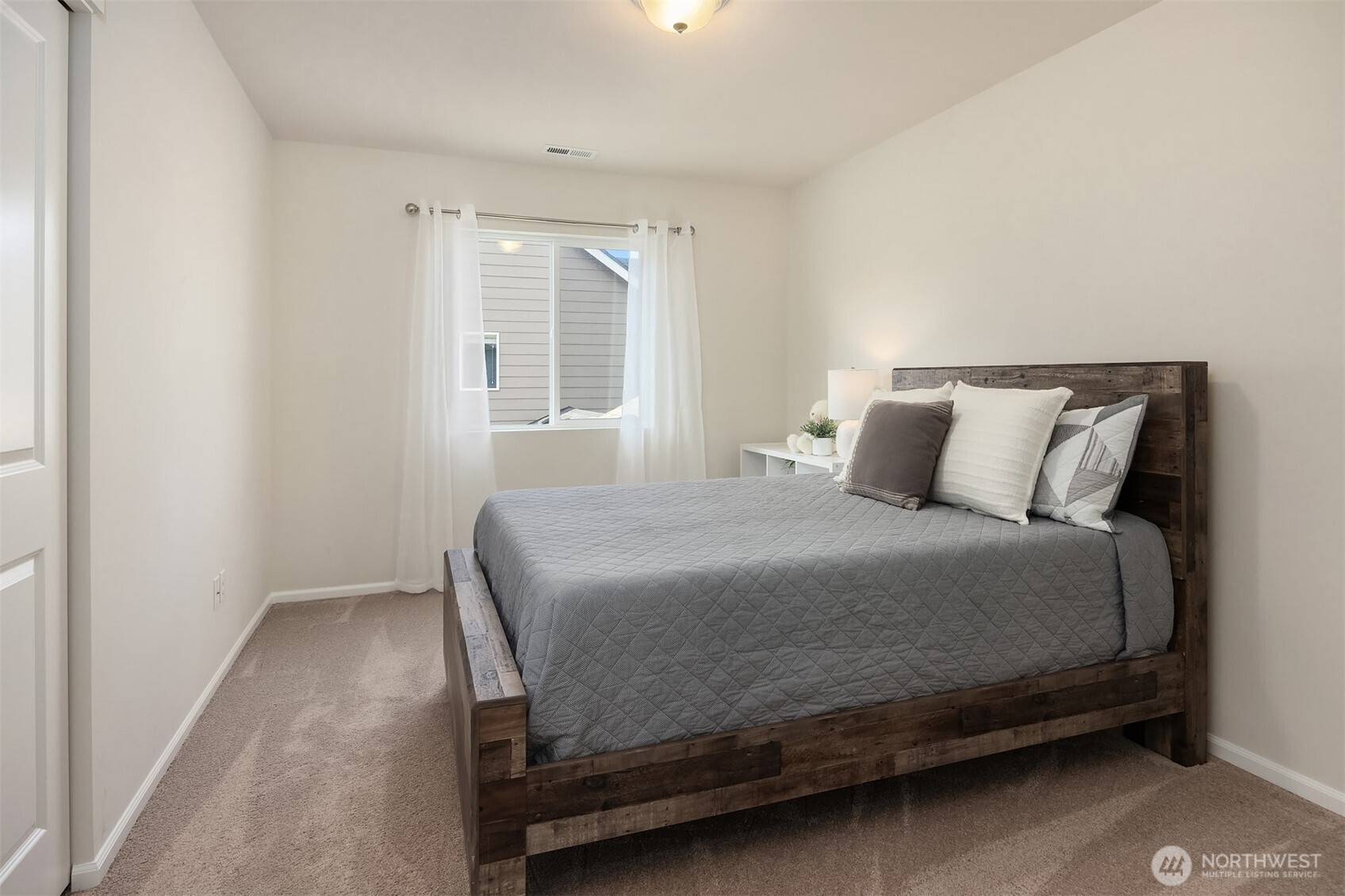 17604 Quartz Street Granite Falls, WA 98252 - Photo 21 of 40 a bedroom with a bed and windows