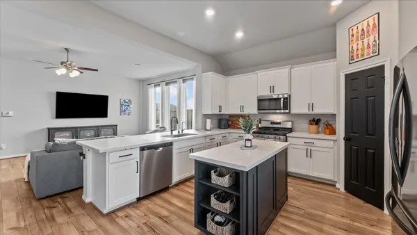 a kitchen with a sink stove and microwave
