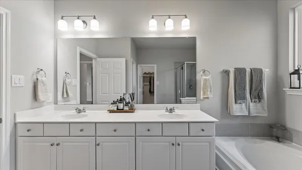 a bathroom with a double vanity sink mirror and double