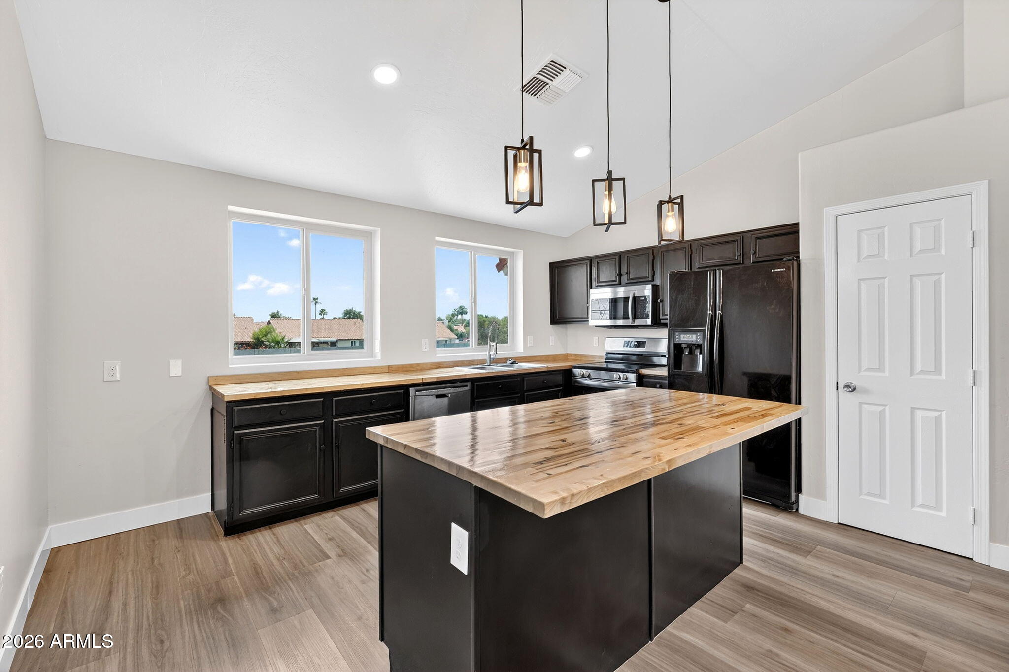 1417 East Mineral Road Gilbert, AZ 85234 - Photo 20 of 59 a kitchen with stainless steel appliances granite countertop wooden cabinets a refrigerator and a sink