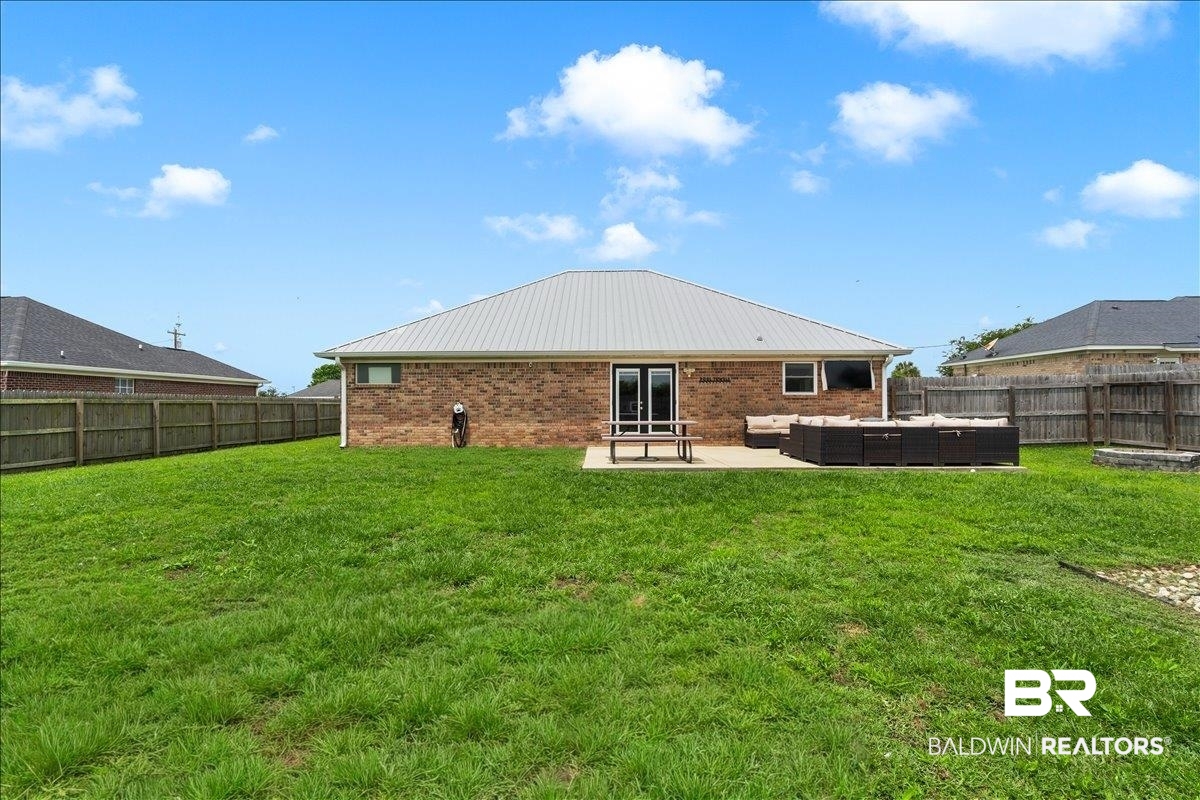 8952 Sherman Road Foley, AL 36535 - Photo 37 of 41 Expansive backyard featuring a brick exterior and a privacy fence
