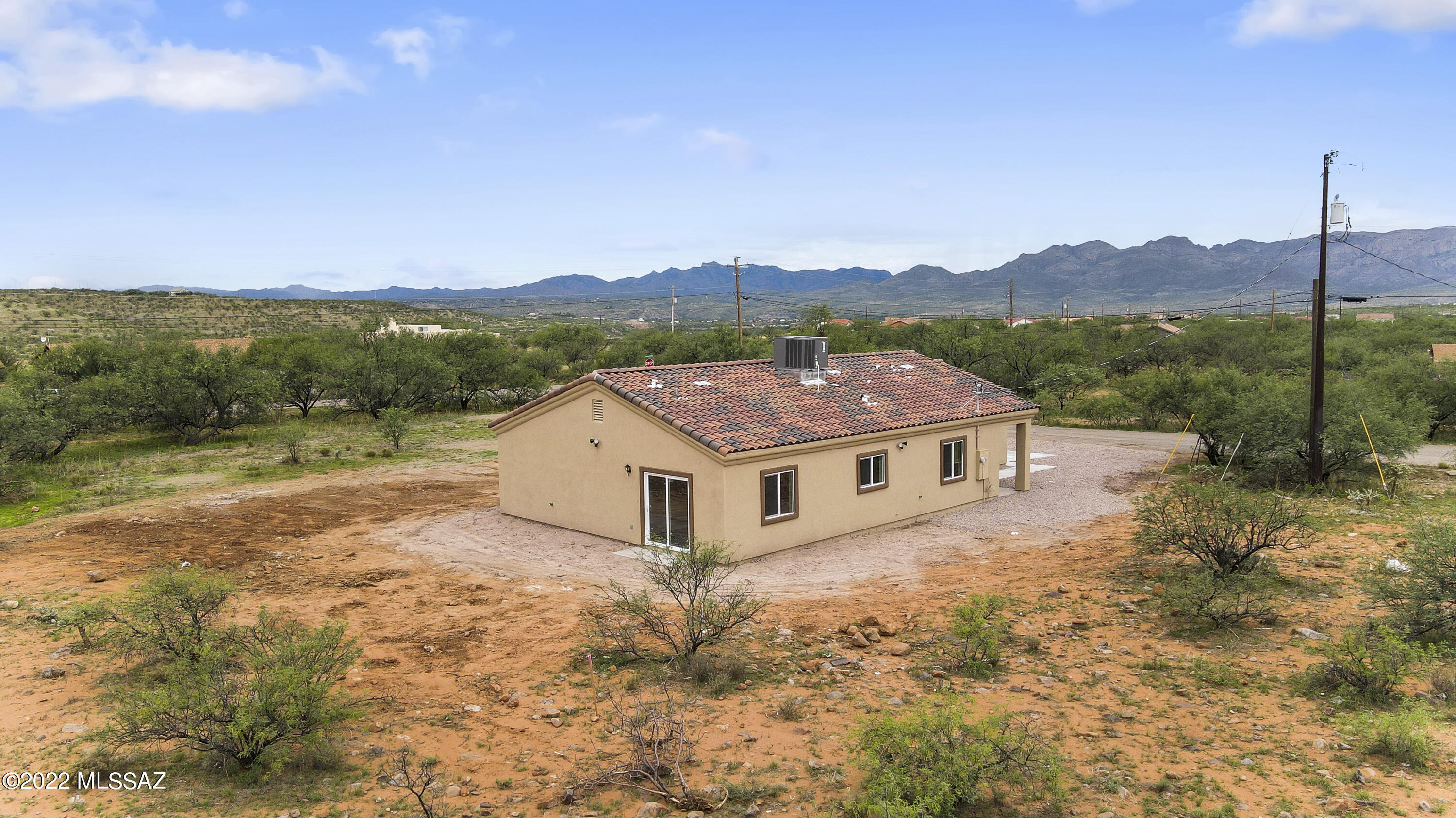 1843 Calle Mulata Rio Rico, AZ 85648 - Photo 4 of 27 a view of a big house with a big yard and large tree