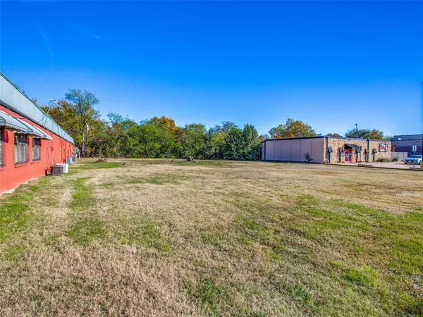 a view of a field with an house in background