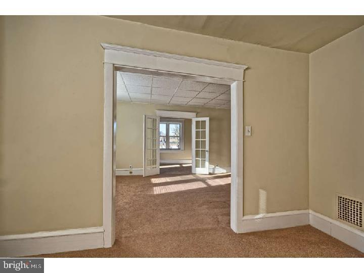 407 North Broadway Pitman, NJ 08071 - Photo 11 of 20 a view of a room with wooden floor and a window