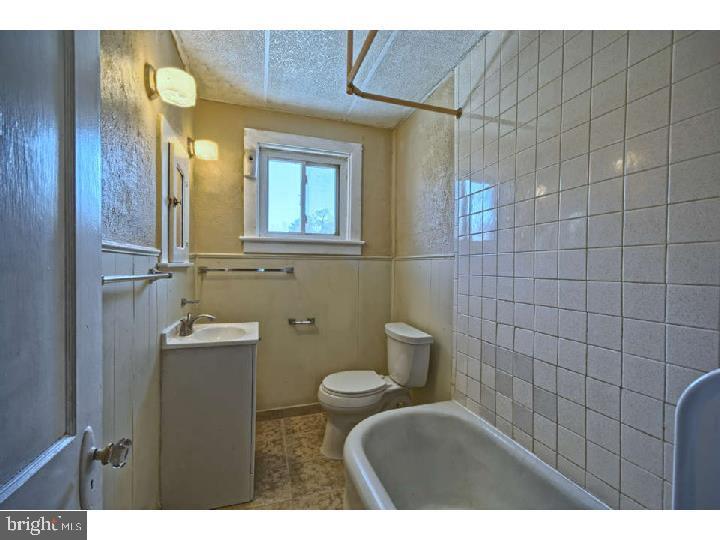 407 North Broadway Pitman, NJ 08071 - Photo 20 of 20 a bathroom with a toilet sink and mirror