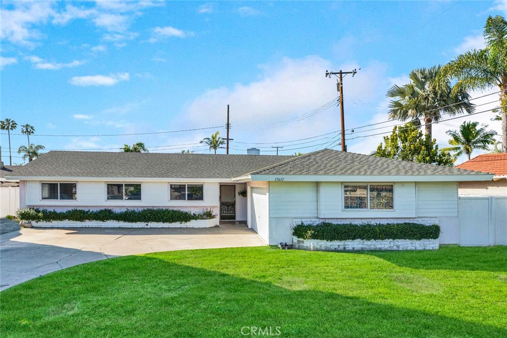 a front view of a house with a garden and plants