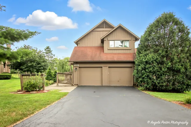 a front view of a house with a garden and yard