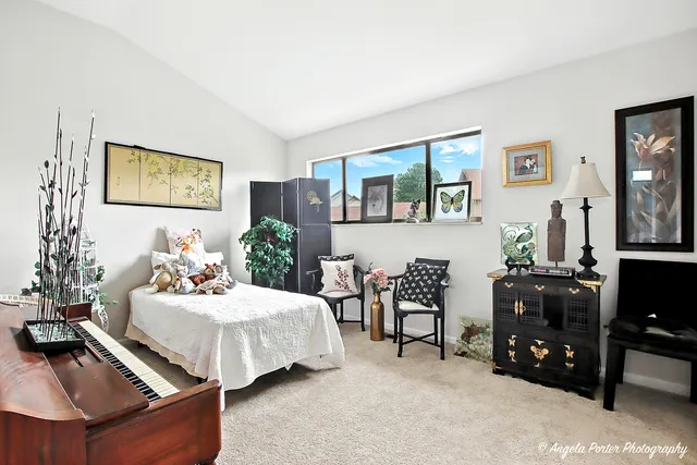 a bedroom with furniture and a flat screen tv