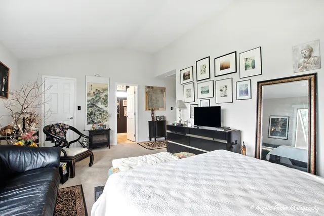 a bedroom with furniture and a flat screen tv