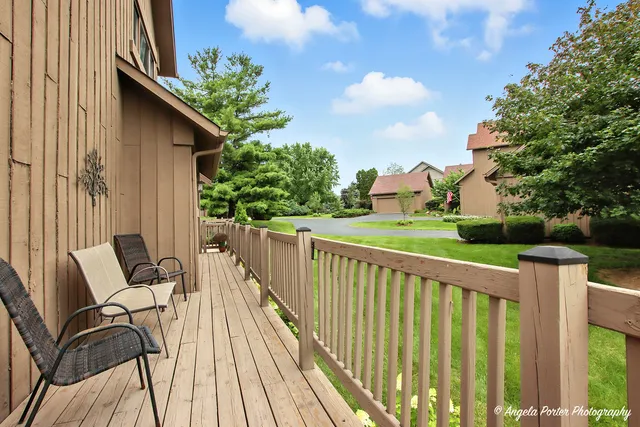 a view of balcony with wooden floor and outdoor seating