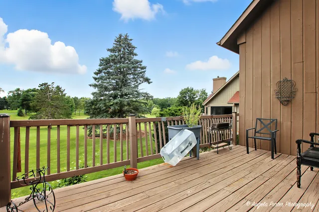 a view of balcony with wooden floor and fence