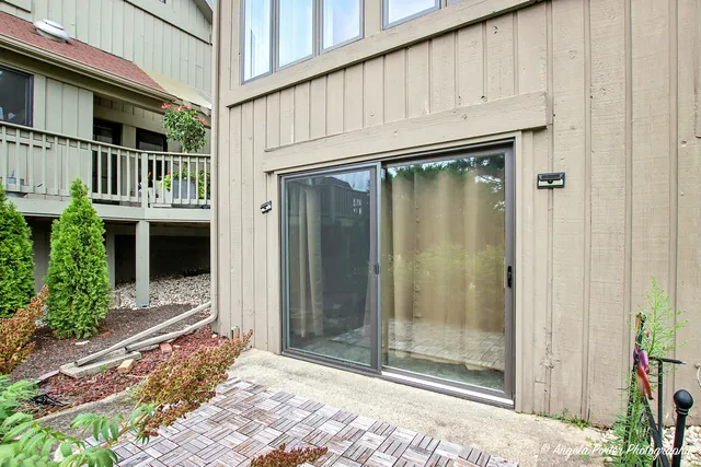 a view of a house with a wooden deck