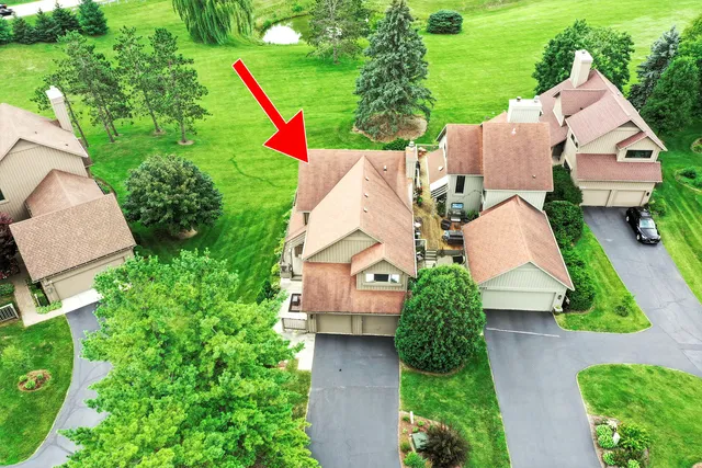 an aerial view of multiple house houses with swimming pool and outdoor seating