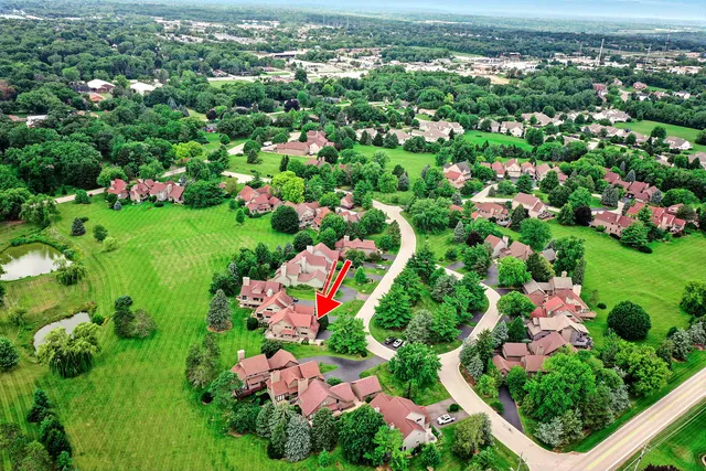 an aerial view of a house with a yard and swimming pool