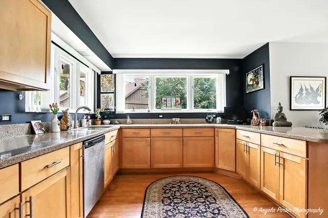 a kitchen with stainless steel appliances granite countertop a sink stove and cabinets