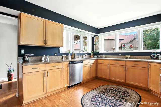 a kitchen with granite countertop a sink stainless steel appliances and cabinets