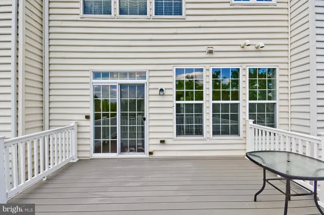 a living room with a couch and a stove next to a window