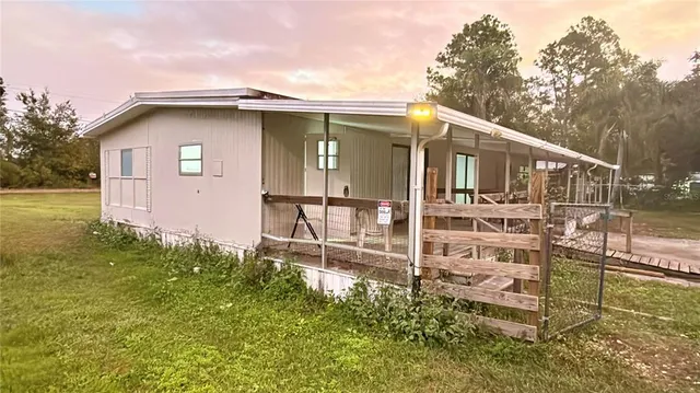 a backyard of a house with table and chairs